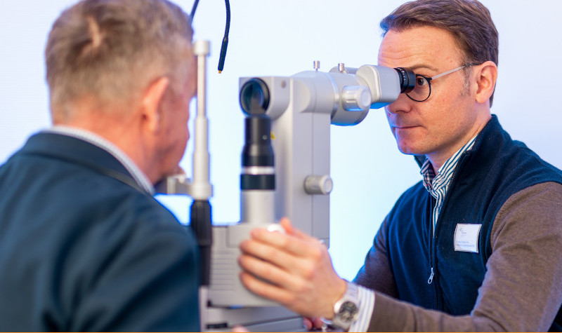 Dr. med. Christian Flöhr von den Augenpartnern untersucht einen Patienten